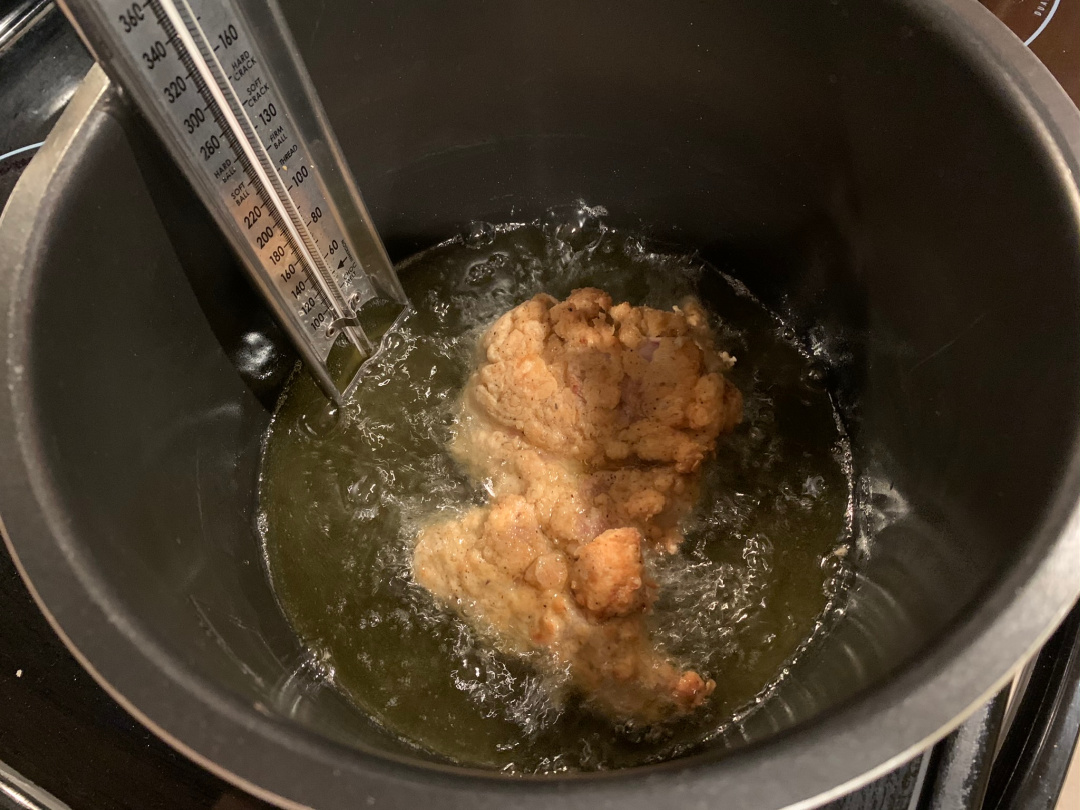 frying chicken in a frying pan
