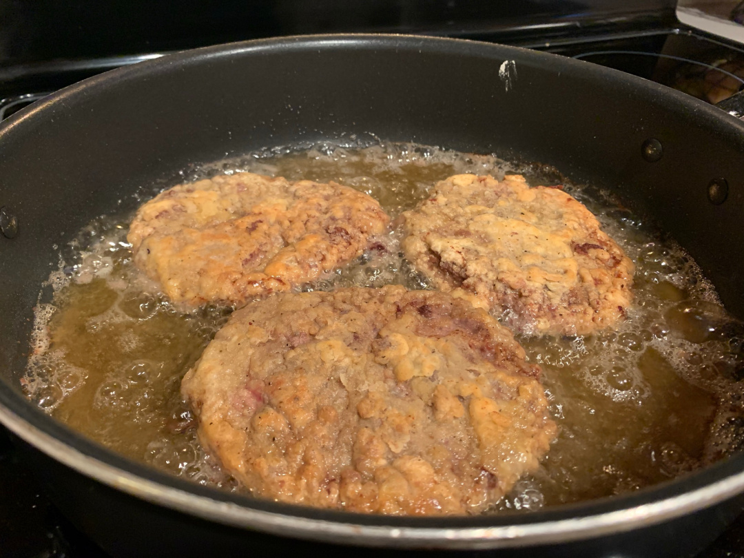 chicken fried steaks in a frying pan
