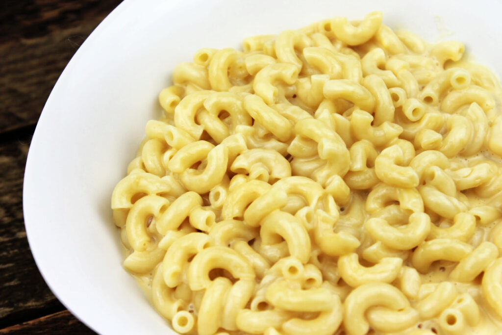 Close-up of creamy homemade mac and cheese with tender elbow macaroni coated in a rich, smooth cheese sauce.