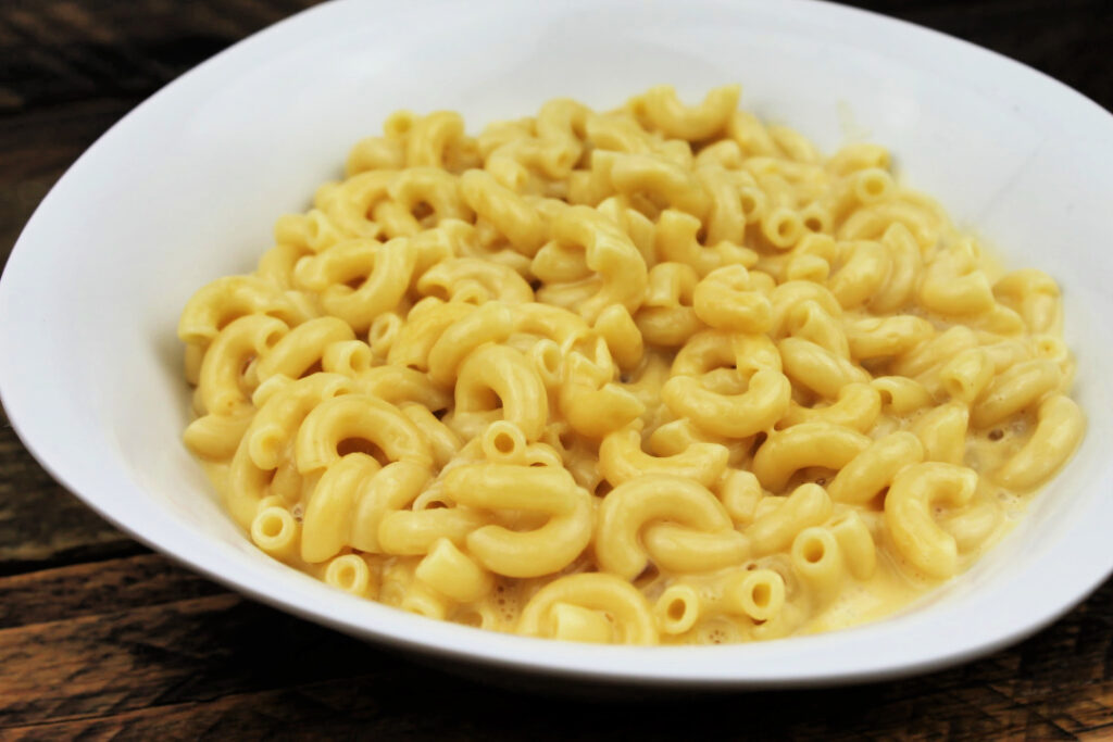 A bowl of creamy homemade mac and cheese with tender elbow macaroni coated in a rich, smooth cheese sauce.