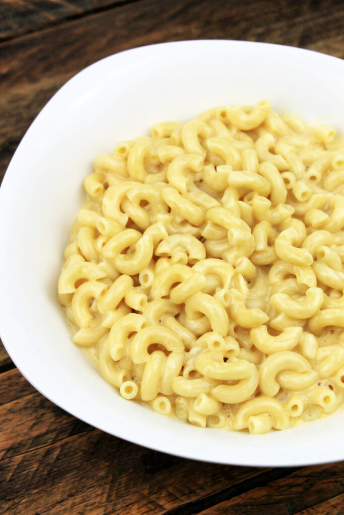 Bowl of easy creamy mac and cheese made with elbow macaroni and a smooth, rich cheese sauce.
