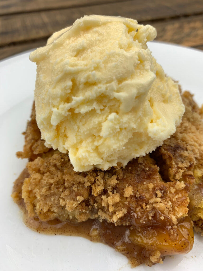 peach cobbler dump cake with ice cream topping
