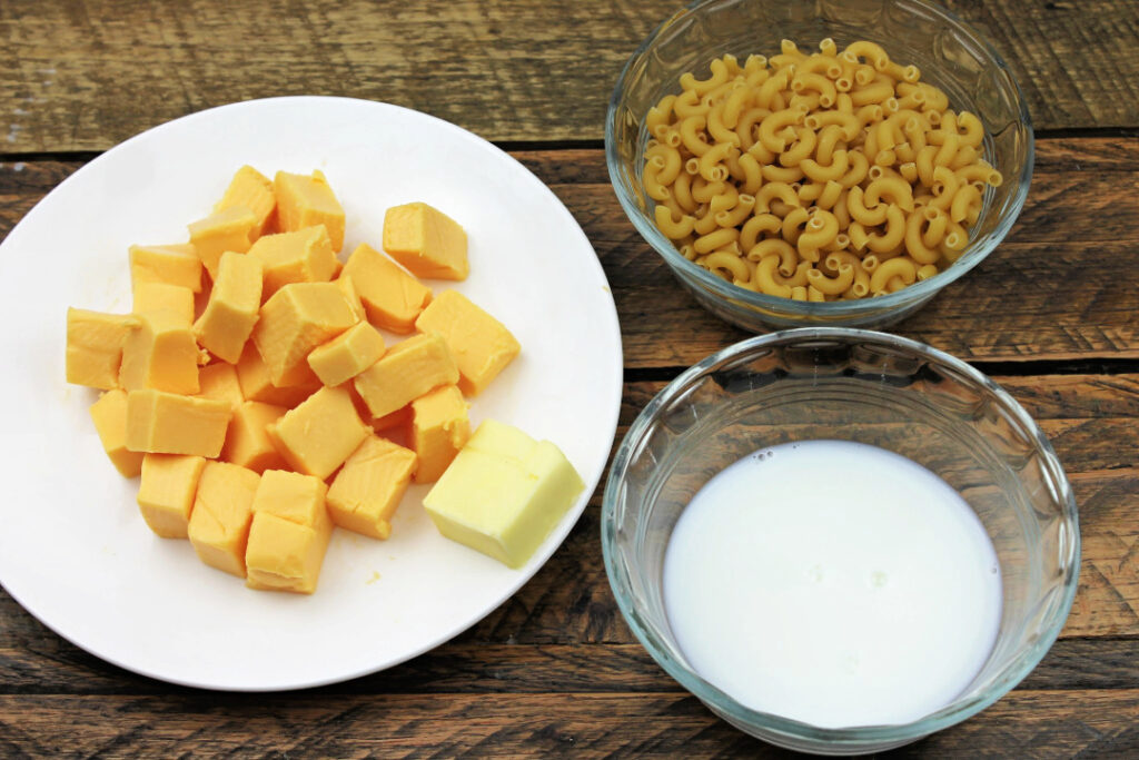 Four simple ingredients for creamy mac and cheese including elbow macaroni, pasteurized cheese product, butter, and half-and-half.
