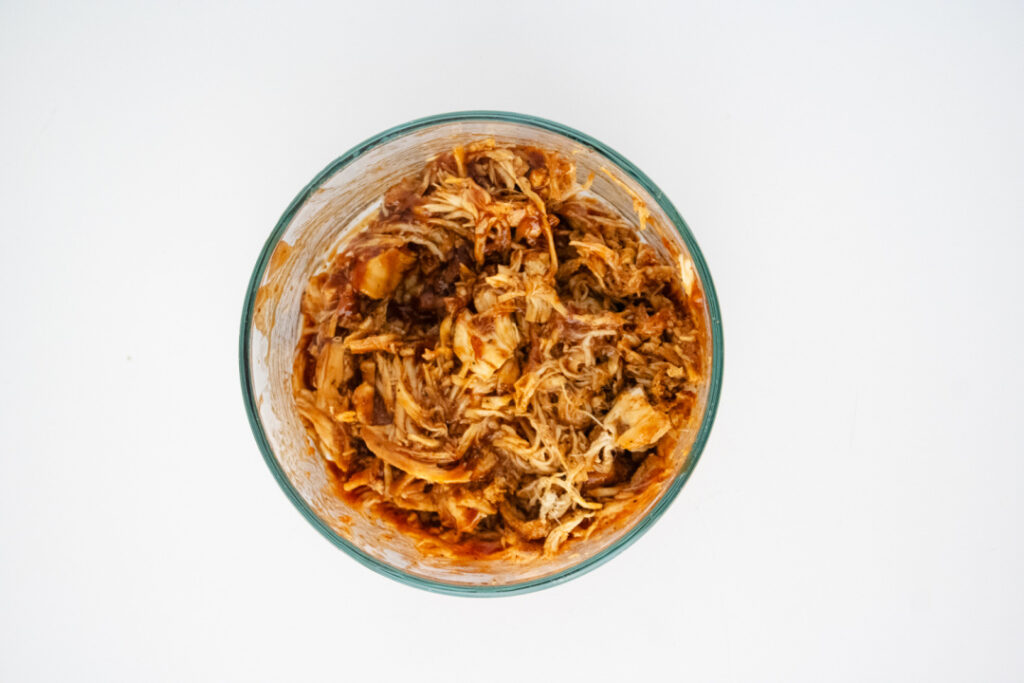 Shredded chicken mixed with BBQ sauce and ready to use as BBQ chicken egg roll filling.