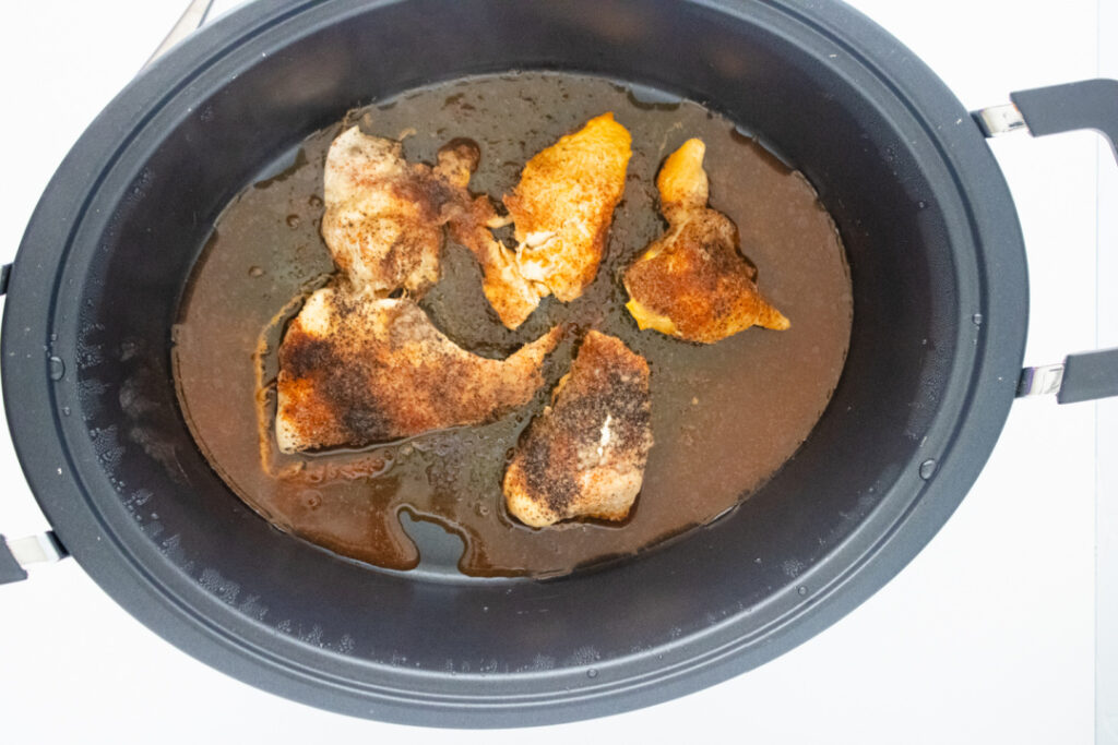 Seasoned chicken cooked until tender in the slow cooker for BBQ chicken egg rolls.