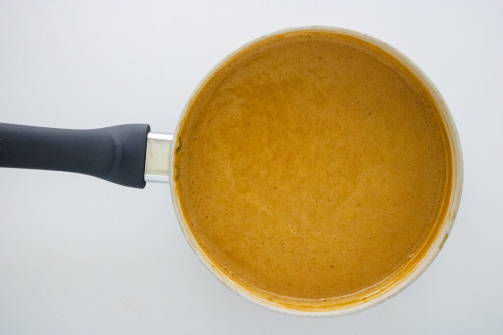 Finished homemade pumpkin spice syrup in a saucepan after simmering