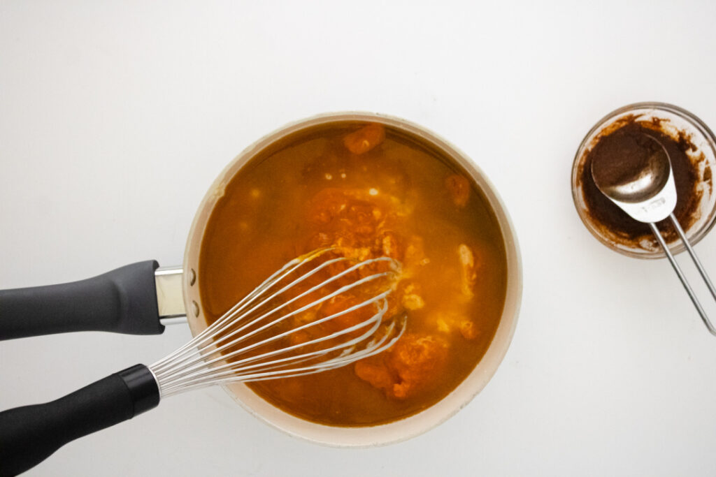 Pumpkin spice syrup mixture whisked together in a saucepan before cooking