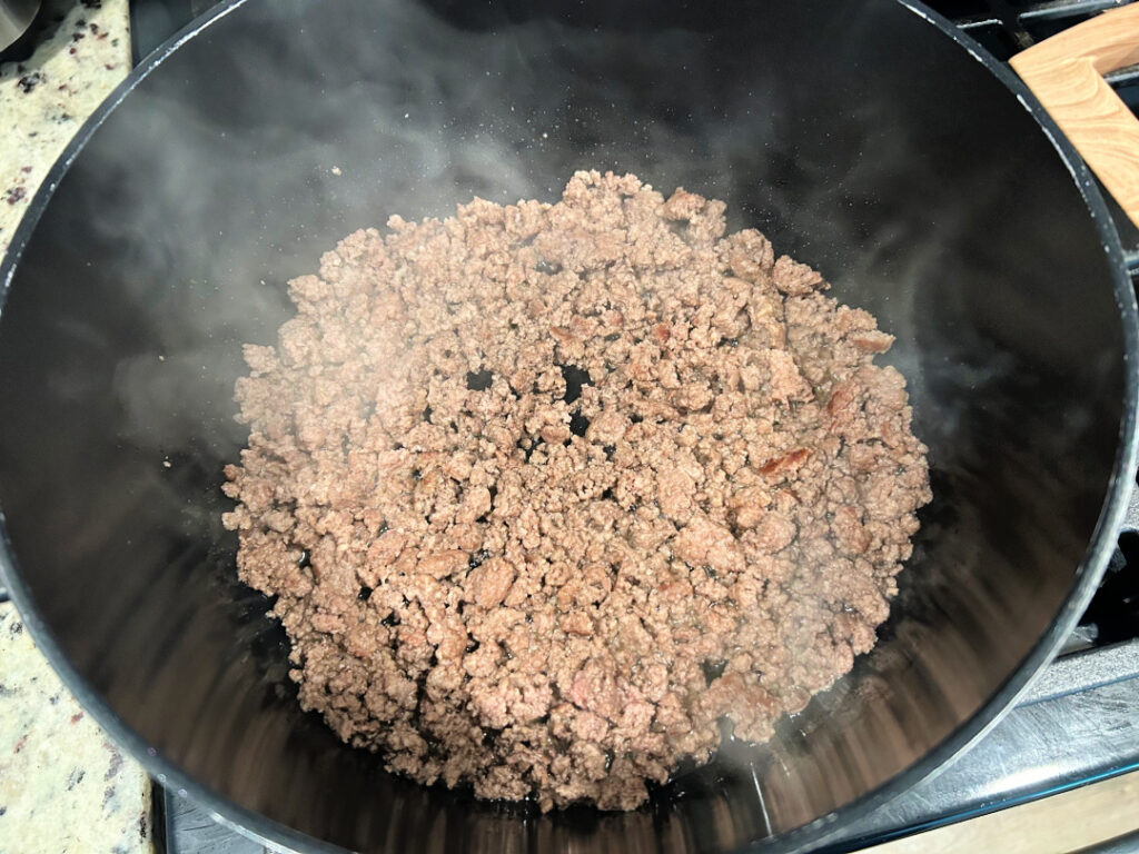 Ground beef browned in a large pot for easy beef and bean chili.